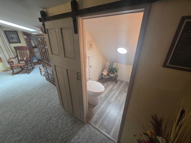 bathroom featuring hardwood / wood-style floors and toilet