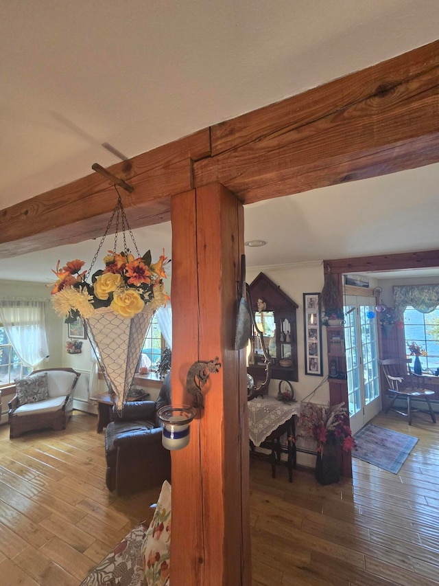 living room with beamed ceiling, french doors, and wood-type flooring