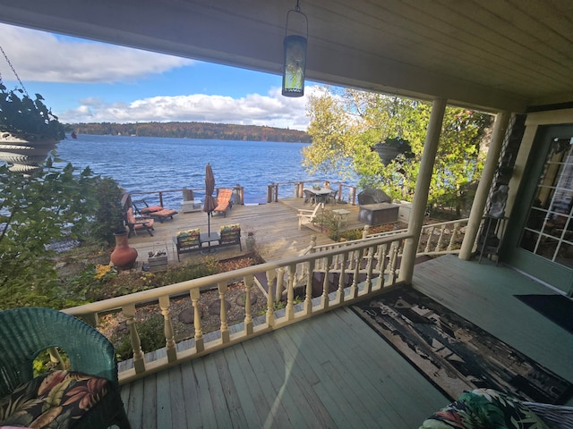 wooden deck featuring a water view