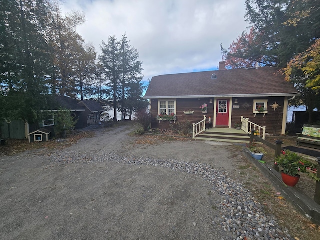 single story home featuring a shed