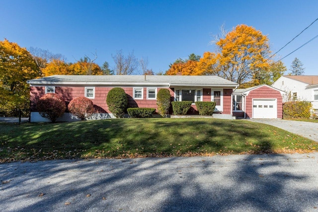 ranch-style home with a front yard and a garage