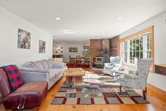 living room featuring light wood-type flooring and a wood stove