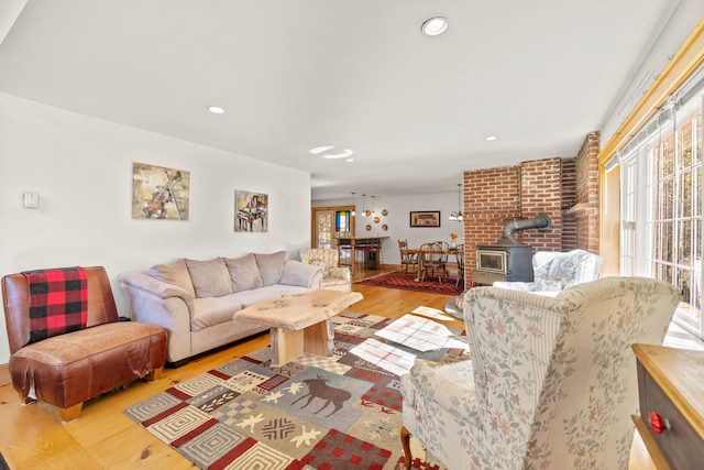 living room featuring light hardwood / wood-style flooring and a wood stove