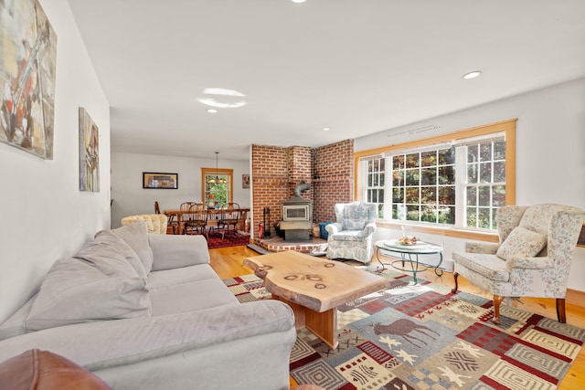 living room featuring hardwood / wood-style flooring and a wood stove