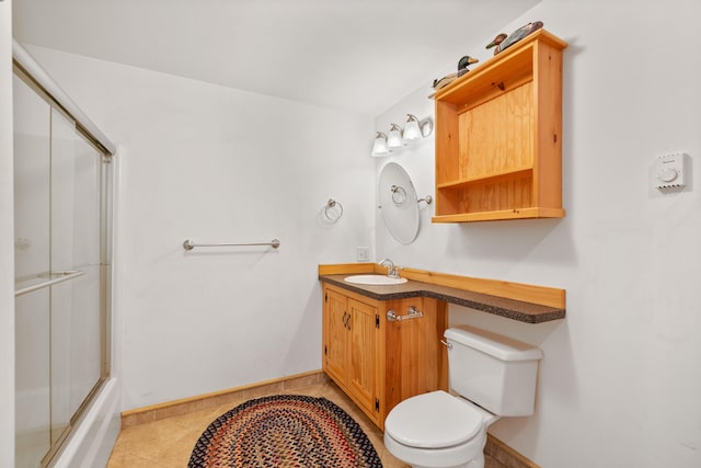 full bathroom featuring vanity, enclosed tub / shower combo, toilet, and tile patterned flooring