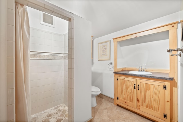 bathroom with vanity, toilet, curtained shower, and tile patterned flooring