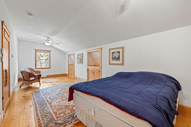 bedroom with lofted ceiling, light wood-type flooring, and ceiling fan