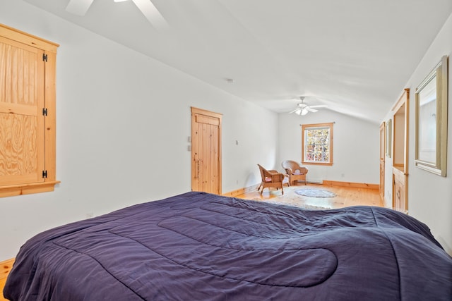 bedroom with lofted ceiling, hardwood / wood-style flooring, and ceiling fan