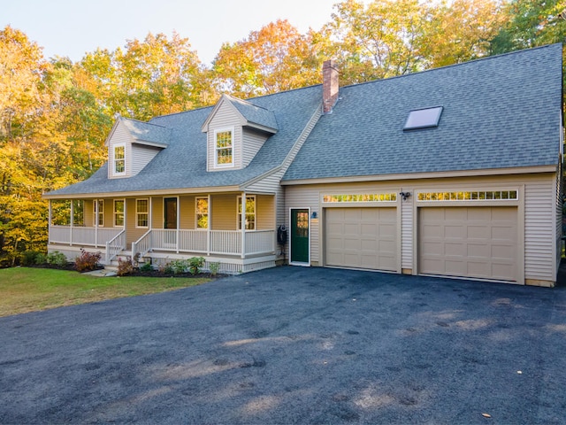 cape cod home with covered porch and a garage