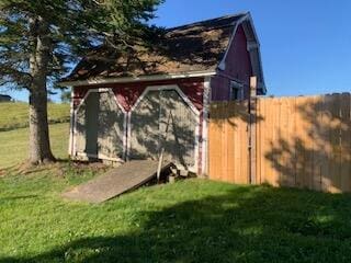 view of outbuilding featuring a lawn