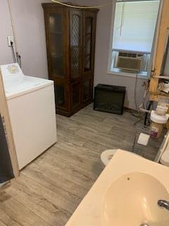 interior space with cooling unit, washer / clothes dryer, and wood-type flooring