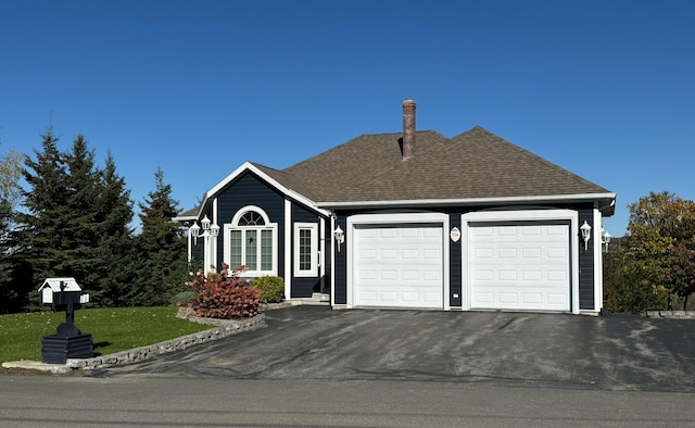 view of front facade with a front yard and a garage