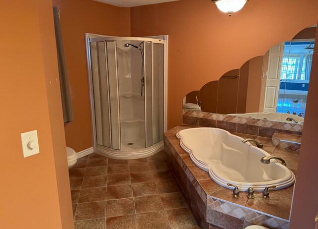 bathroom featuring tile patterned floors, plus walk in shower, and toilet