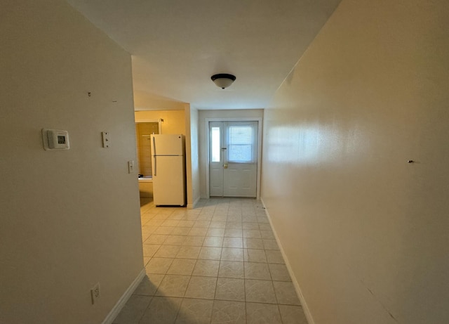 hall featuring light tile patterned flooring