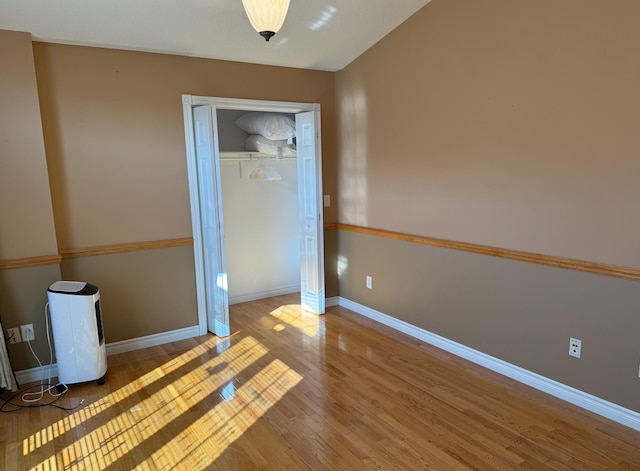 unfurnished bedroom with wood-type flooring and a closet