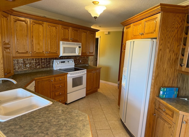 kitchen with light tile patterned floors, backsplash, ornamental molding, sink, and white appliances