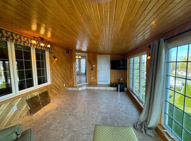 unfurnished sunroom with wood ceiling and lofted ceiling