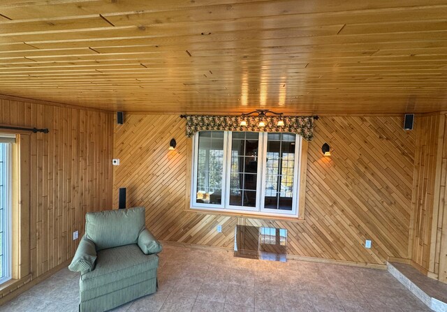 unfurnished room with wooden walls and wooden ceiling