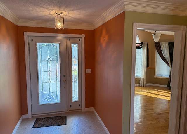 entryway featuring crown molding, light hardwood / wood-style floors, and a healthy amount of sunlight