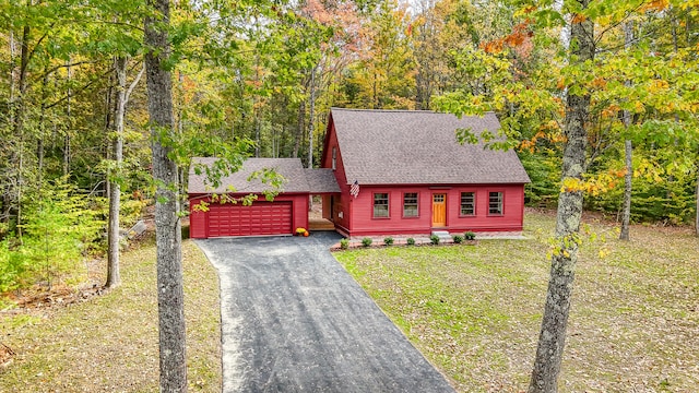 view of front facade with a garage and a front yard