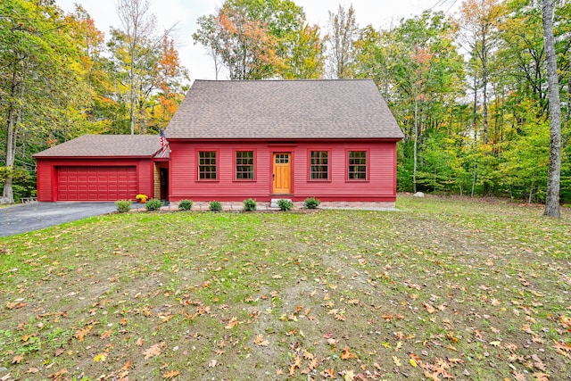 view of front of house with a front lawn and a garage