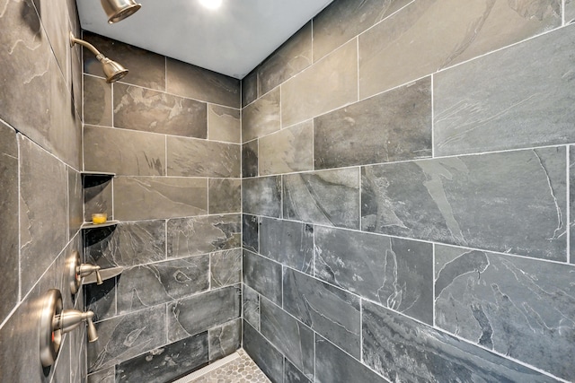 bathroom with tiled shower