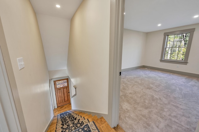 corridor with light hardwood / wood-style floors