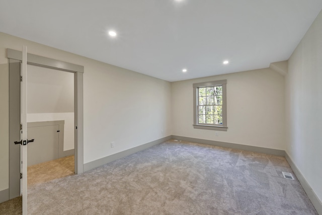 unfurnished room with light carpet