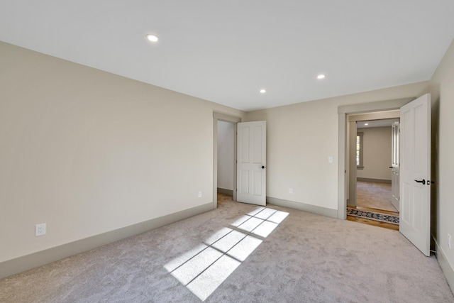 unfurnished bedroom featuring light colored carpet