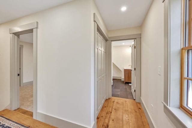 corridor with light wood-type flooring