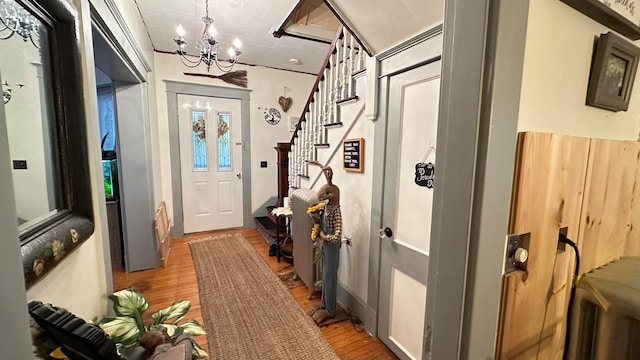 interior space with a notable chandelier and hardwood / wood-style floors