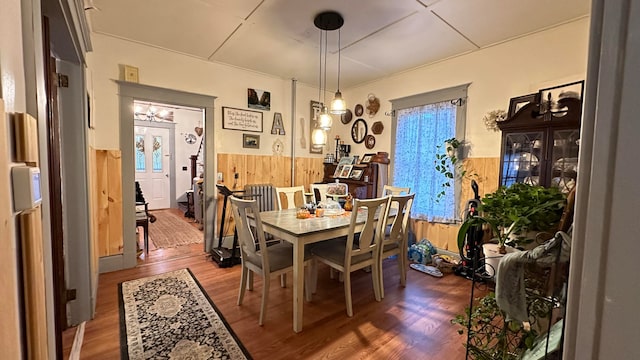 dining space featuring wooden walls and hardwood / wood-style floors