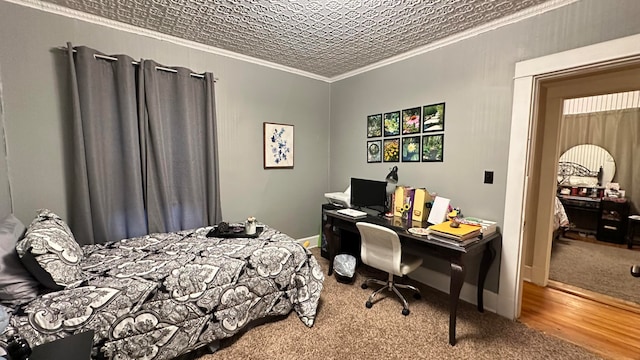 bedroom featuring hardwood / wood-style floors and crown molding