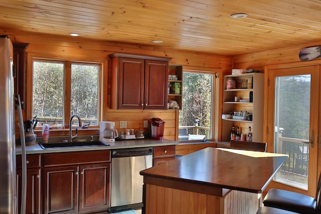 kitchen with appliances with stainless steel finishes, sink, wooden ceiling, and a kitchen island