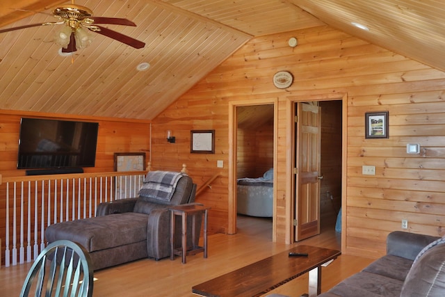 living room with ceiling fan, high vaulted ceiling, wooden ceiling, light wood-type flooring, and wooden walls