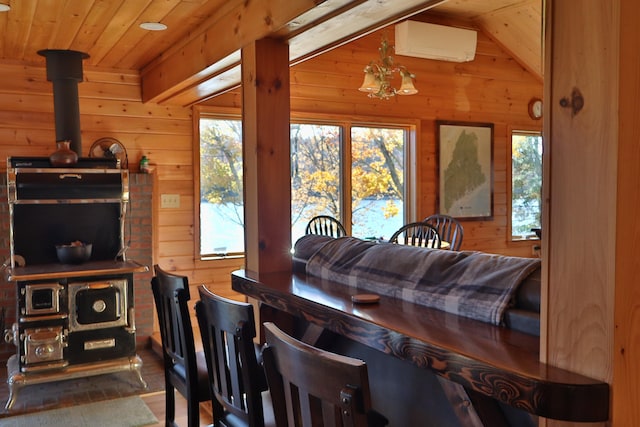 dining area featuring vaulted ceiling with beams, an AC wall unit, plenty of natural light, and wood walls