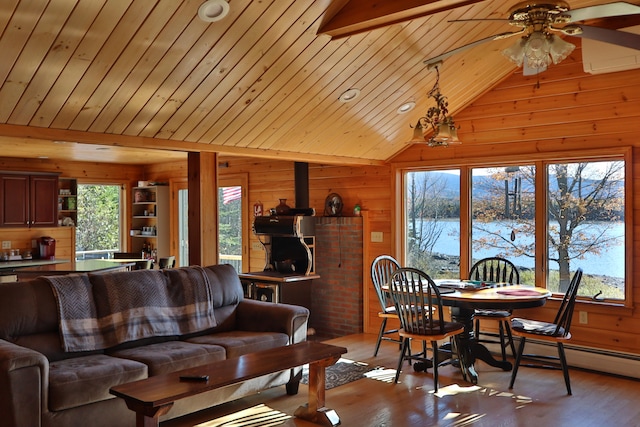 living room with a water view, light wood-type flooring, and plenty of natural light