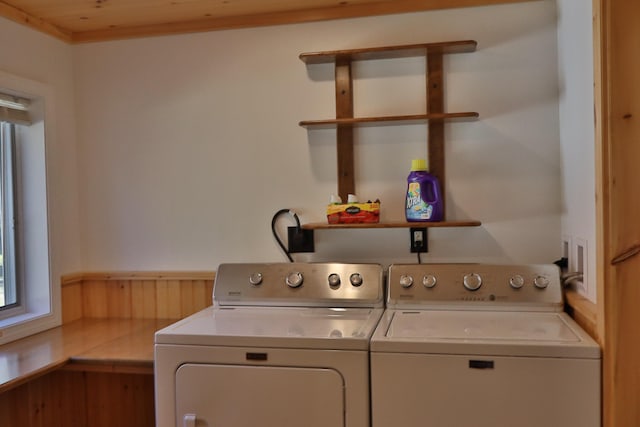 laundry room featuring wood ceiling, wood walls, and washer and clothes dryer