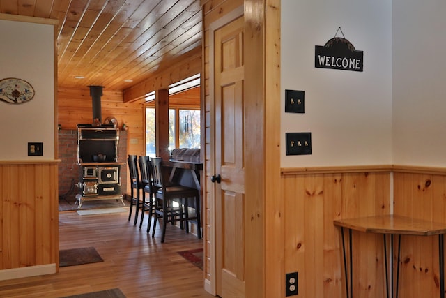 interior space with wooden ceiling, wood-type flooring, and wooden walls