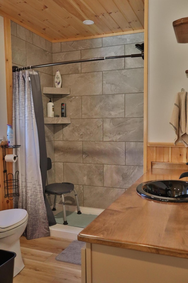 bathroom with wood-type flooring, wood ceiling, a shower with curtain, and toilet