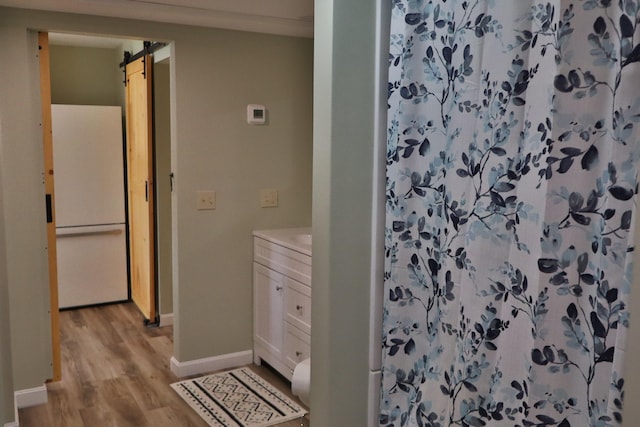 bathroom with vanity, hardwood / wood-style floors, and curtained shower