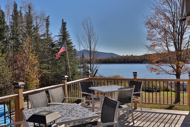 wooden terrace featuring a water and mountain view