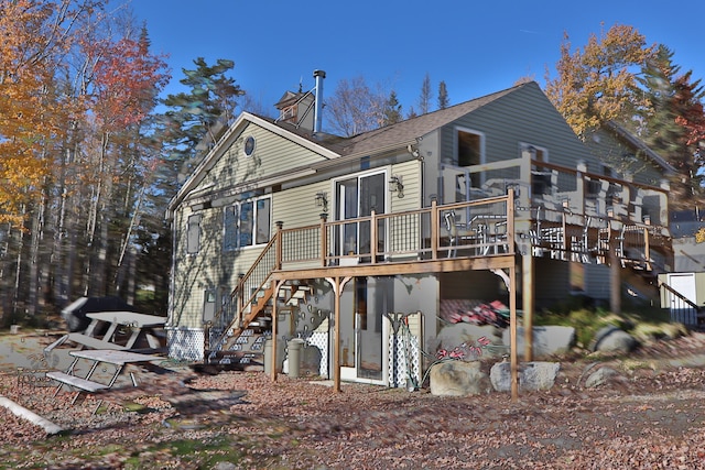 rear view of house featuring a wooden deck