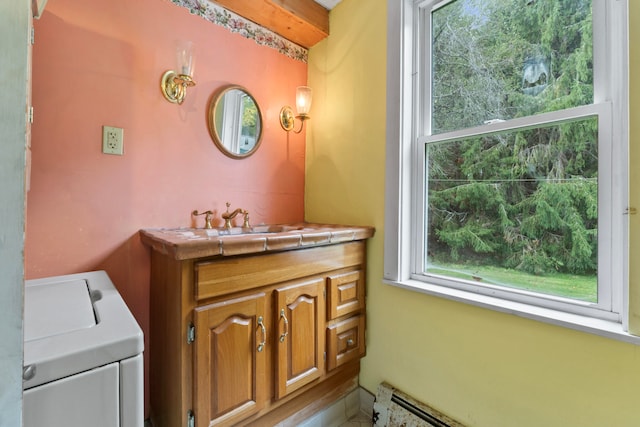 bathroom with vanity and washer / clothes dryer