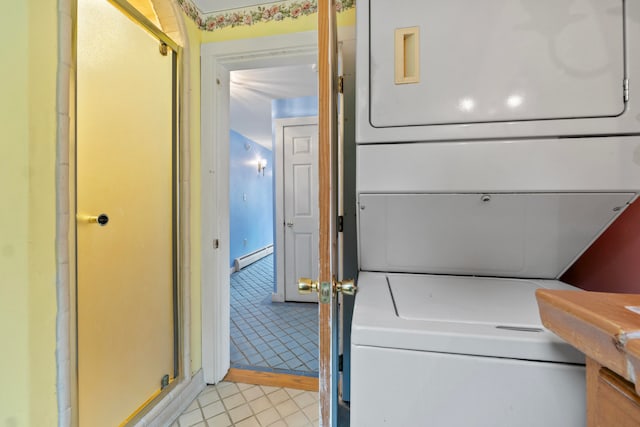 laundry area featuring stacked washer and dryer and a baseboard heating unit