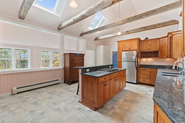 kitchen with appliances with stainless steel finishes, a skylight, sink, a center island, and baseboard heating