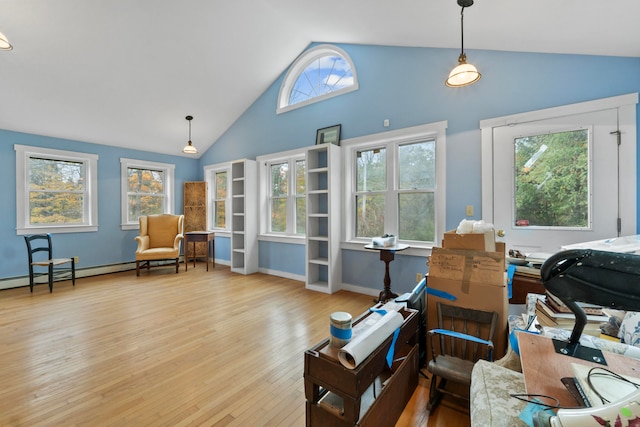 living area with light hardwood / wood-style floors, a healthy amount of sunlight, and lofted ceiling