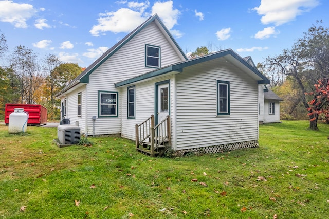 rear view of house with a yard