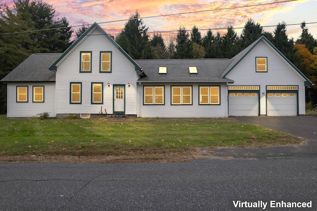 view of front facade with a garage and a lawn