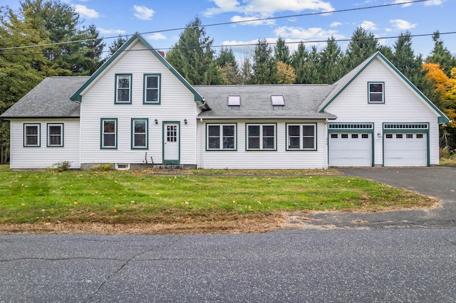 view of front of property with a front yard and a garage